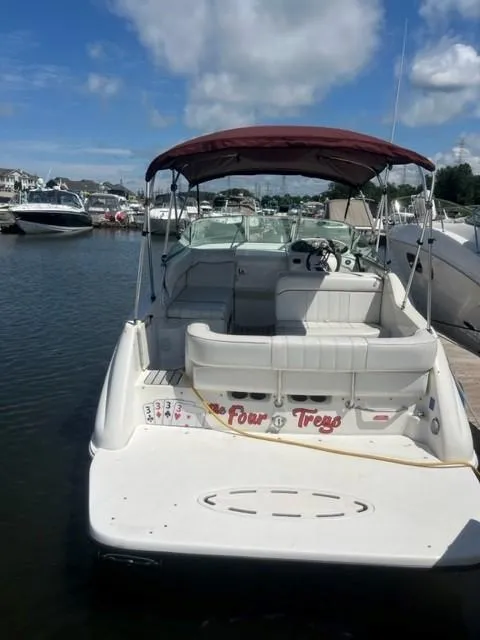 Slide: The Image of 1996 Sea Ray Sundancer boat docked at marina under blue sky. - 4