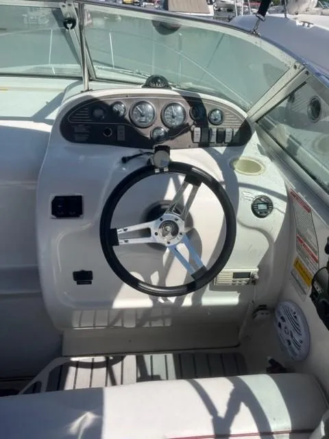 Slide: The Image of 1996 Sea Ray Sundancer boat cockpit with steering wheel and instrument panel. - 9