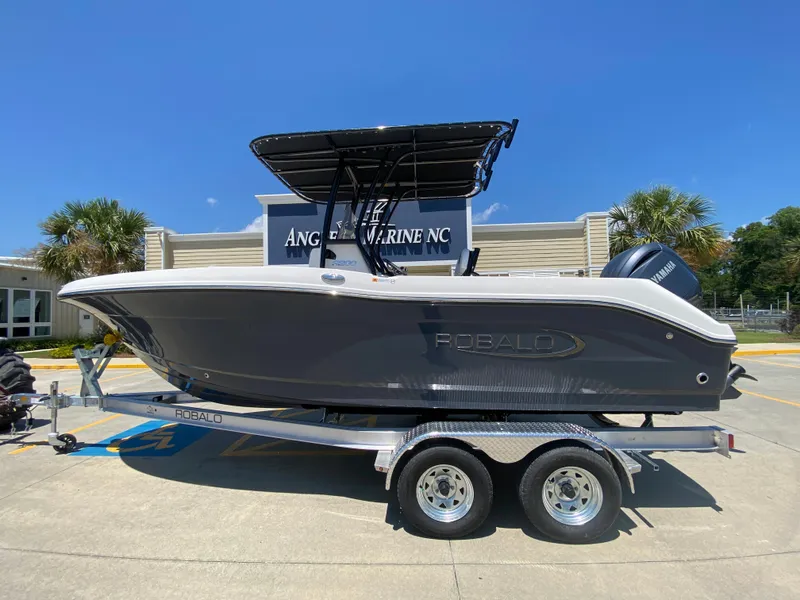 The Image of 2026 Robalo R200 Center Console boat on trailer, parked outside dealership. - 0