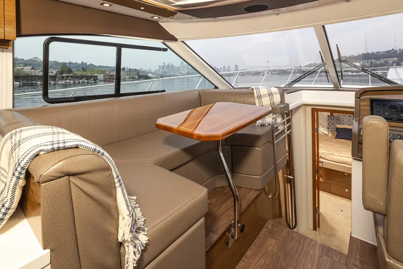 Slide: The Image of 2018 Cruisers Yachts 45 Cantius interior with dining area and panoramic windows. - 14
