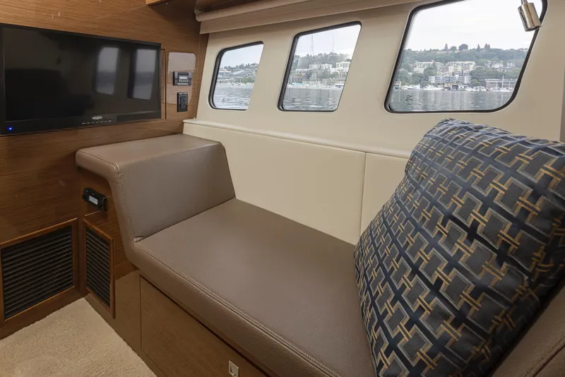 Slide: The Image of Interior lounge area of 2018 Cruisers Yachts 45 Cantius with TV and waterfront view. - 22