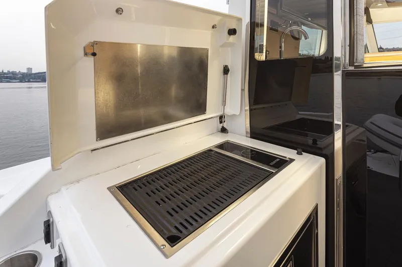 Slide: The Image of Outdoor grill on 2018 Cruisers Yachts 45 Cantius, docked by the water. - 28