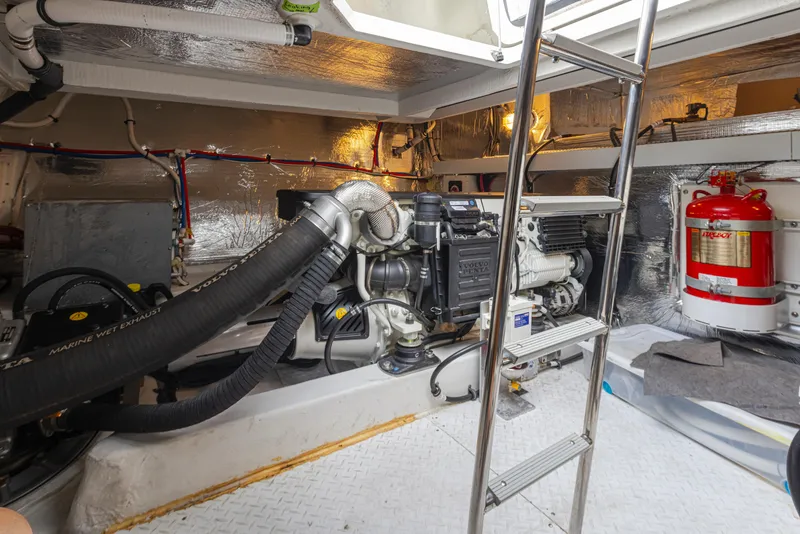 Slide: The Image of Engine room of a 2018 Cruisers Yachts 45 Cantius with visible machinery and ladder. - 38