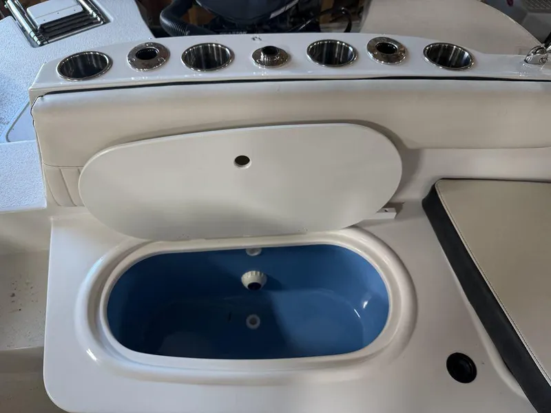 Slide: The Image of 2024 Stingray 192SC boat interior with cup holders and storage compartment. - 10