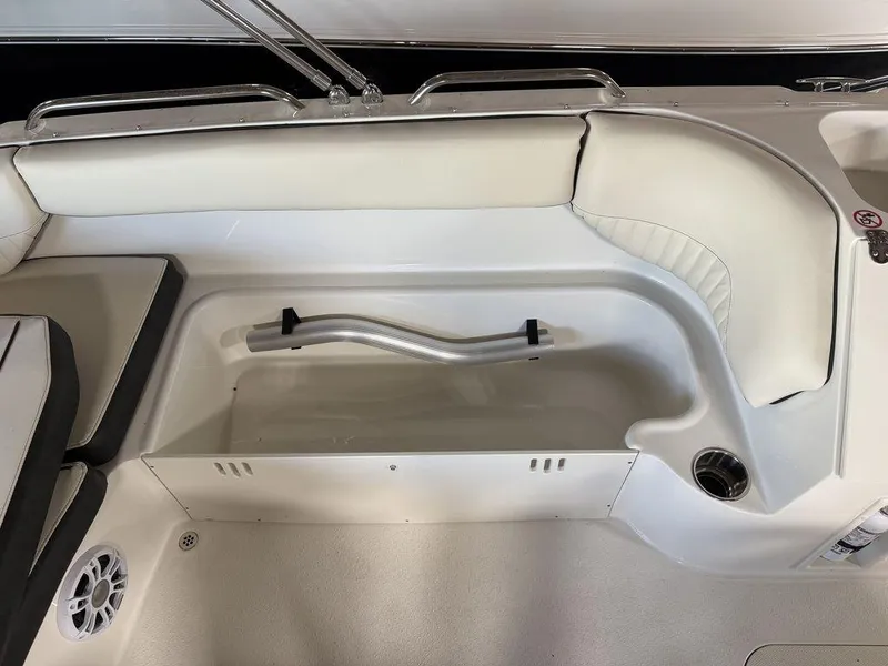 Slide: The Image of 2024 Stingray 192SC boat interior with white seating and storage compartment. - 14