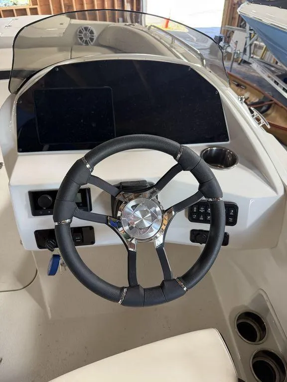 Slide: The Image of 2024 Stingray 192SC boat dashboard with steering wheel and control panel. - 17