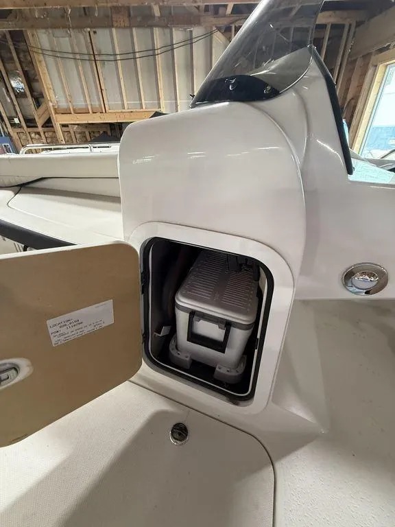 Slide: The Image of 2024 Stingray 192SC boat interior with storage compartment open, showcasing compact design. - 21