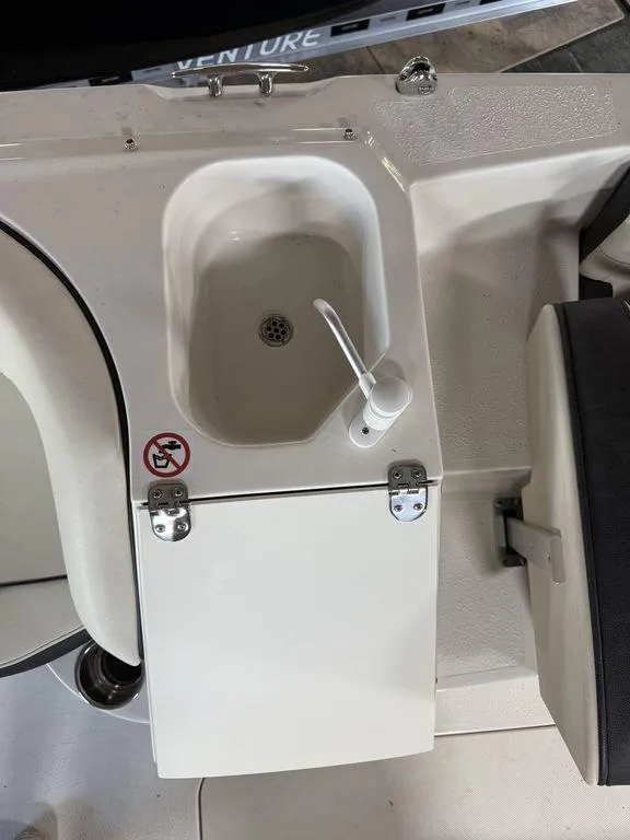 Slide: The Image of 2024 Stingray 192SC boat sink with faucet and storage compartment. - 23