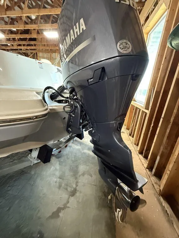 Slide: The Image of 2024 Stingray 192SC boat with Yamaha outboard motor in a wooden garage. - 3