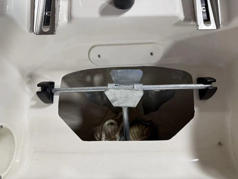 Slide: The Image of 2024 Stingray 192SC boat anchor storage compartment with anchor and rope. - 31