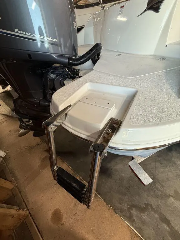 Slide: The Image of 2024 Stingray 192SC boat with a four-stroke engine and foldable swim ladder. - 5