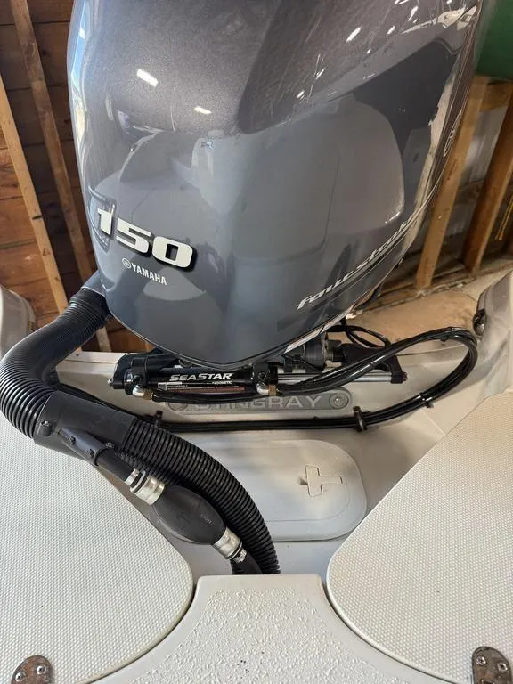 Slide: The Image of 2024 Stingray 192SC boat with Yamaha 150 outboard motor in a garage setting. - 6