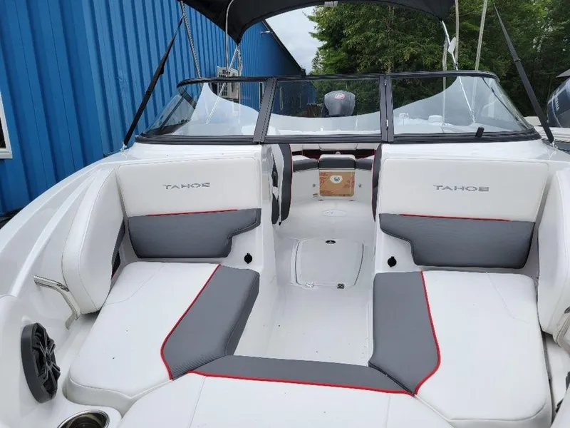 Slide: The Image of 2024 Tahoe 210 S boat interior with white and gray seating. - 11