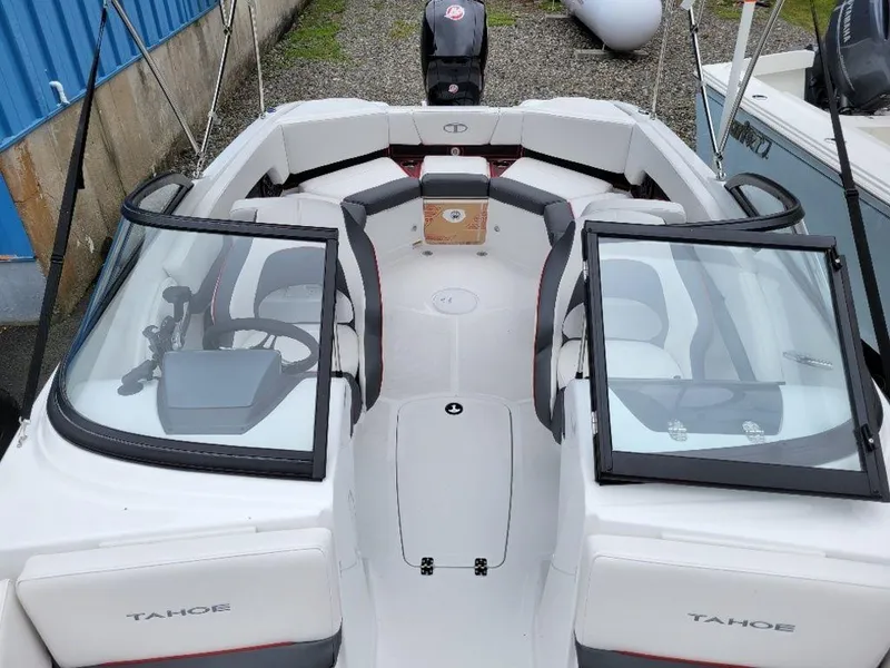 Slide: The Image of 2024 Tahoe 210 S boat with open bow seating and dual consoles. - 2