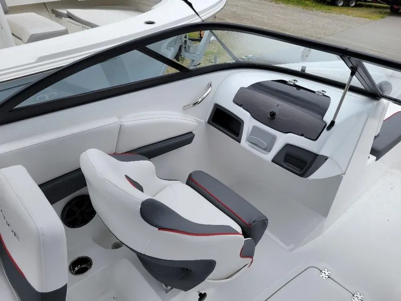 Slide: The Image of 2024 Tahoe 210 S boat interior with white and gray seating, modern dashboard. - 3