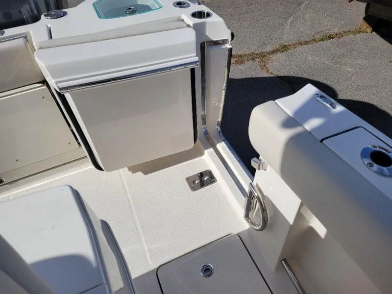 Slide: The Image of 2024 Sailfish 272 CC boat interior, featuring a clean, white deck and seating area. - 11