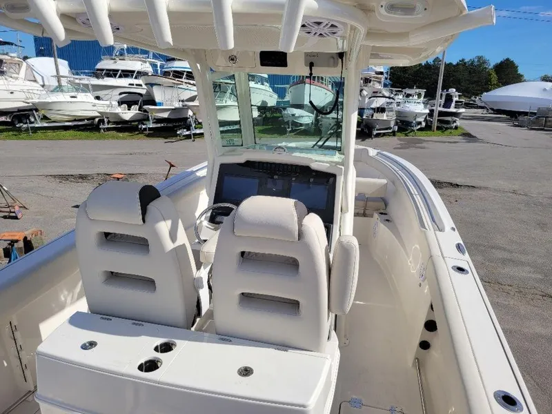 Slide: The Image of 2024 Sailfish 272 CC center console boat with dual seats and modern dashboard. - 14