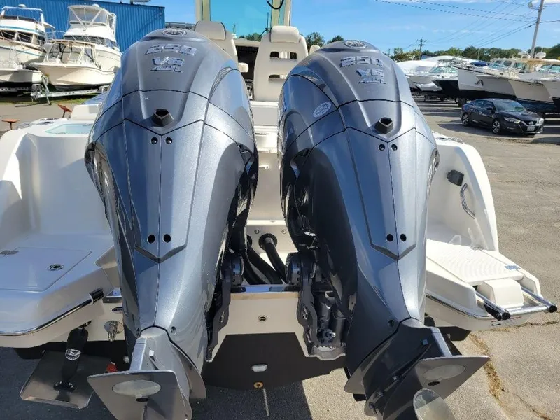 Slide: The Image of 2024 Sailfish 272 CC with twin outboard engines at a marina. - 17