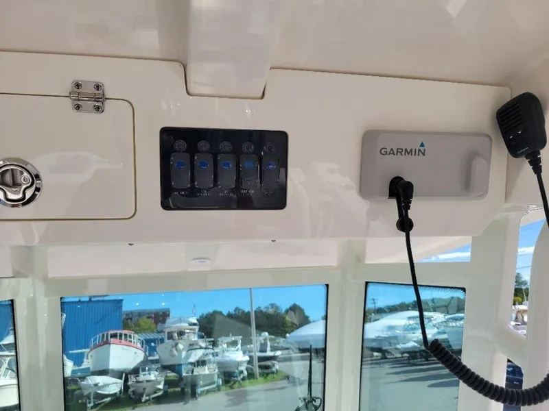 Slide: The Image of Control panel and Garmin device on 2024 Sailfish 272 CC boat. - 19