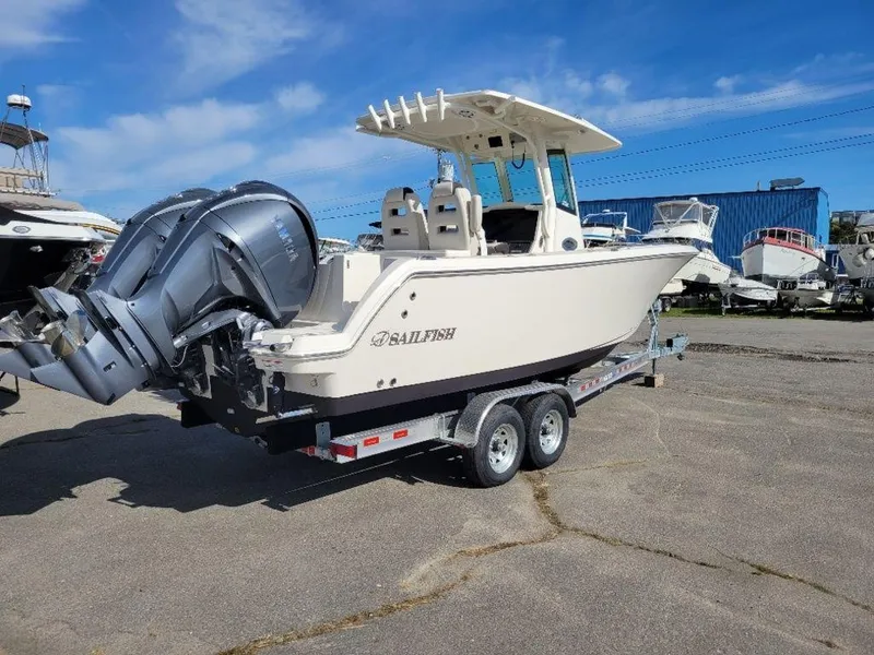 Slide: The Image of 2024 Sailfish 272 CC boat on a trailer with twin outboard engines. - 20