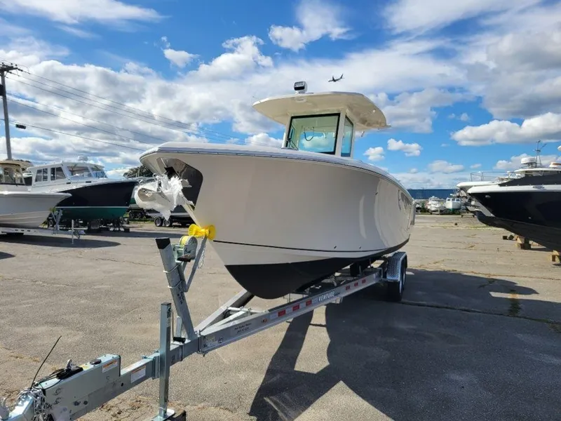 Slide: The Image of 2024 Sailfish 272 CC boat on trailer under a blue sky. - 3