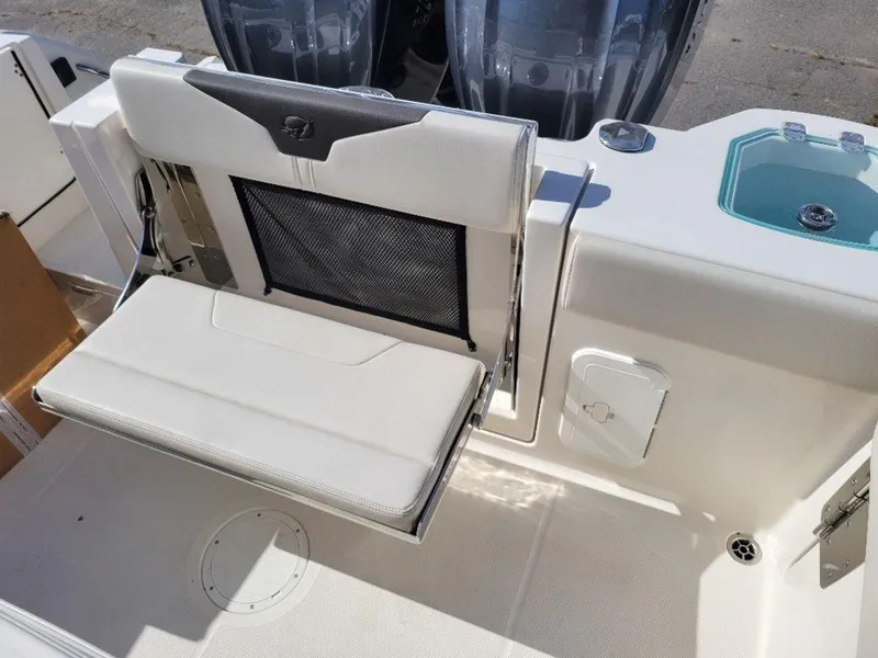 Slide: The Image of 2024 Sailfish 272 CC boat with foldable rear seat and dual outboard motors. - 7