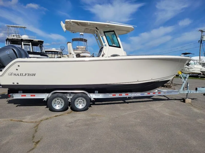 Slide: The Image of 2024 Sailfish 272 CC boat on a trailer under a blue sky. - 9