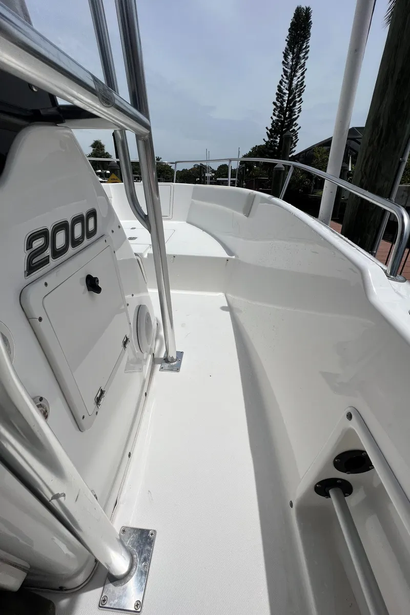Slide: The Image of 2004 Century 2000 Center Console boat deck with railing and storage compartment. - 11