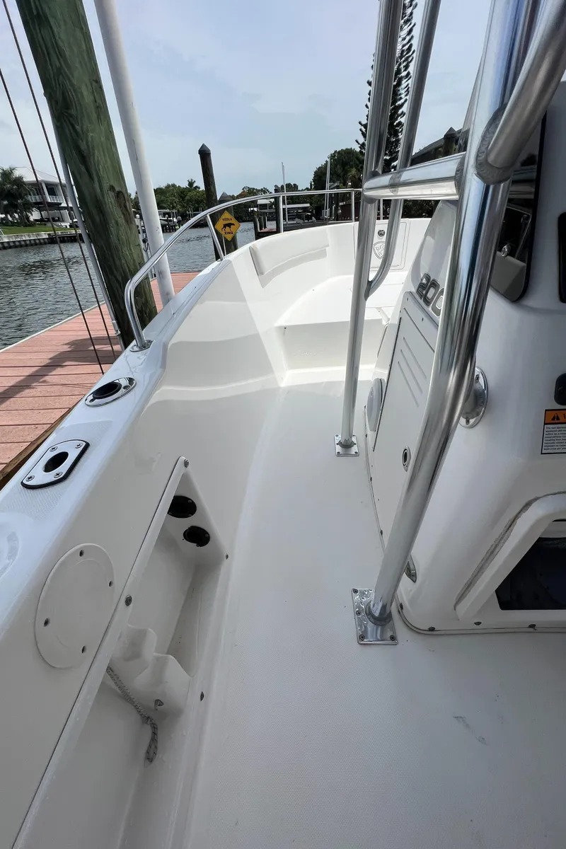 Slide: The Image of 2004 Century 2000 Center Console boat docked by a wooden pier. - 12