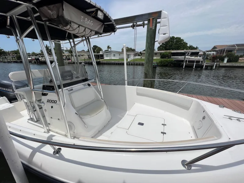 Slide: The Image of 2004 Century 2000 Center Console boat docked by waterfront homes. - 13