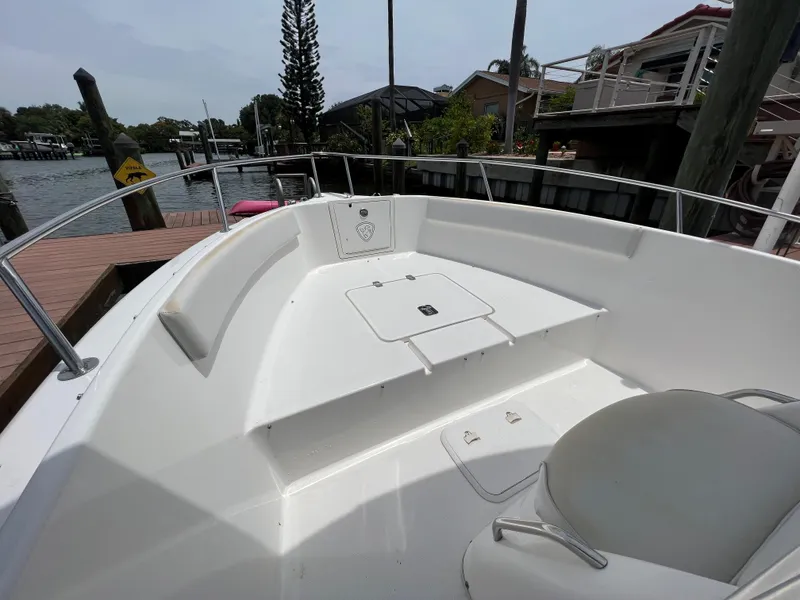 Slide: The Image of 2004 Century 2000 Center Console boat, spacious deck, docked by waterfront homes. - 14