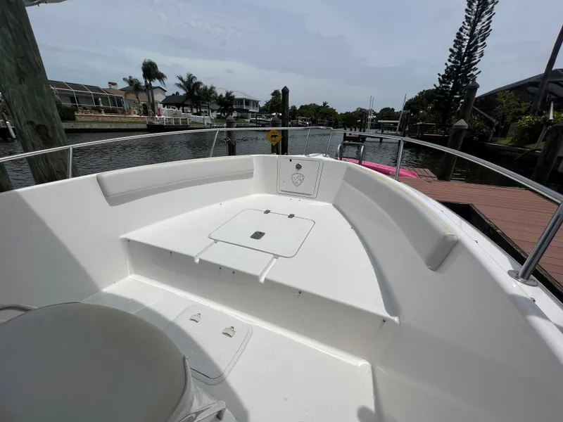 Slide: The Image of 2004 Century 2000 Center Console boat docked by a scenic waterfront. - 15