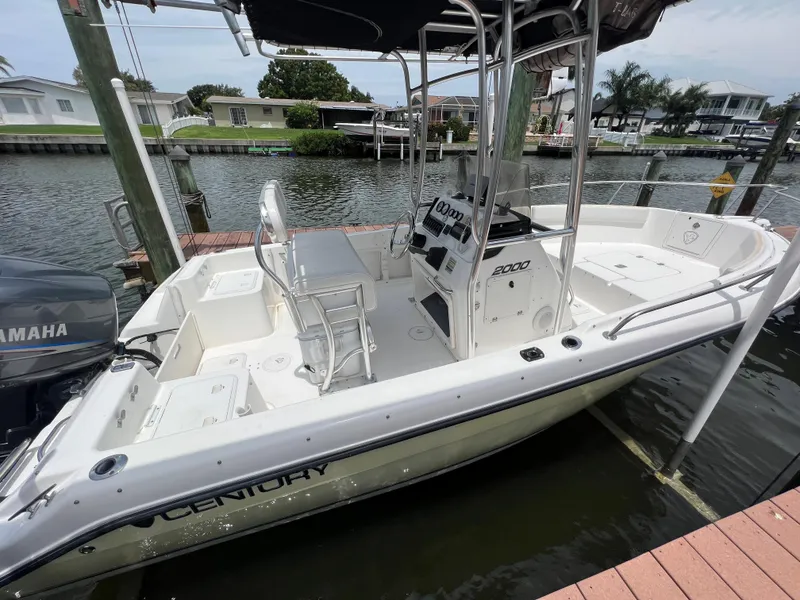 Slide: The Image of 2004 Century 2000 Center Console boat docked by waterfront homes. - 3