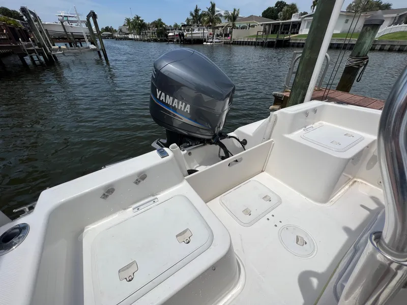 Slide: The Image of 2004 Century 2000 Center Console boat with Yamaha outboard motor on a calm waterway. - 5