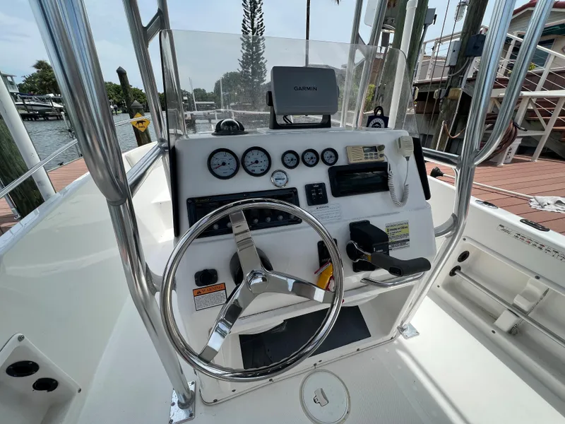 Slide: The Image of 2004 Century 2000 Center Console boat dashboard with steering wheel and gauges. - 9