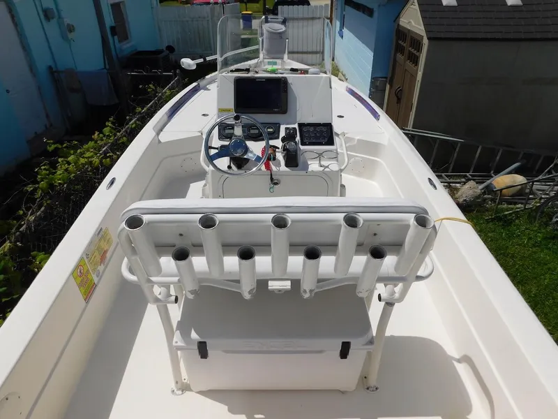 Slide: The Image of 2016 Skeeter 240SX boat interior with steering console and rod holders. - 10