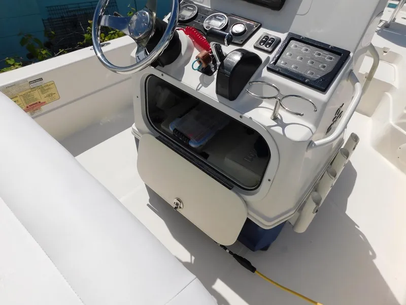 Slide: The Image of 2016 Skeeter 240SX boat console with steering wheel and controls. - 11