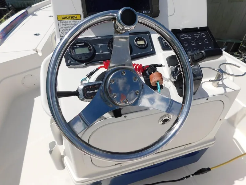 Slide: The Image of Steering wheel of a 2016 Skeeter 240SX boat with control panel and gauges. - 12