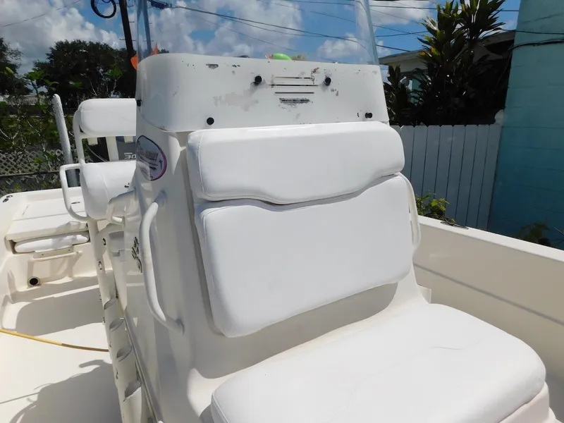 Slide: The Image of 2016 Skeeter 240SX boat with white seating and console, outdoors under blue sky. - 18