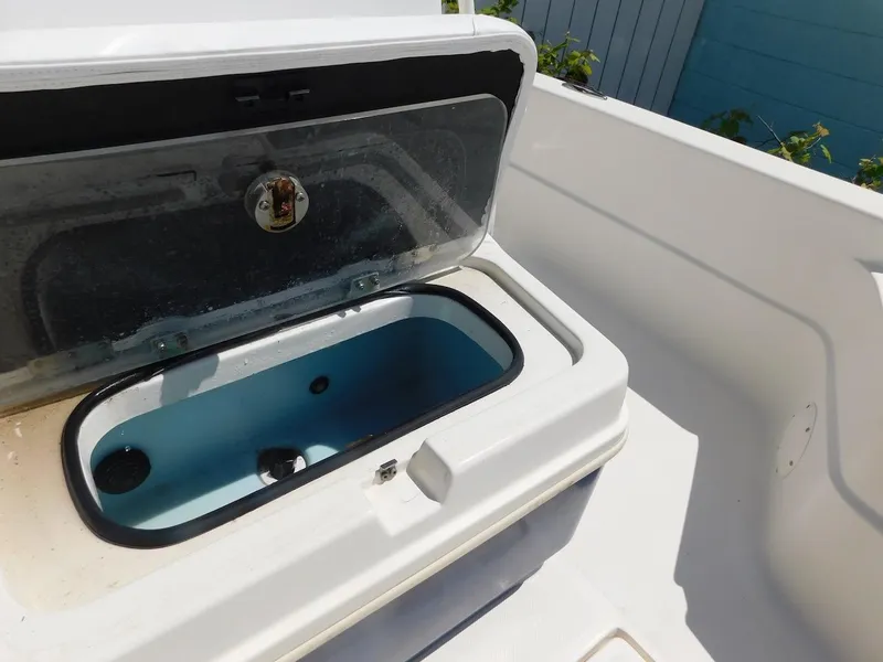 Slide: The Image of Open storage compartment on 2016 Skeeter 240SX boat. - 19