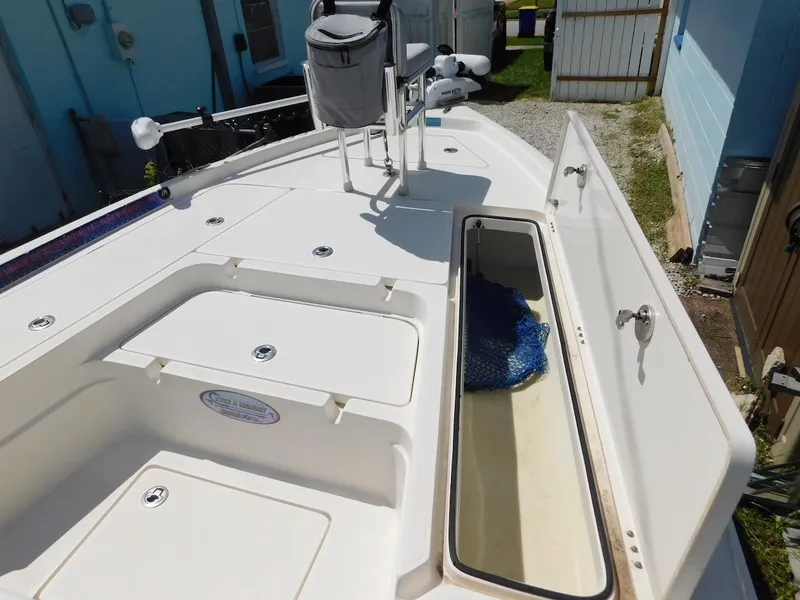 Slide: The Image of 2016 Skeeter 240SX boat deck with open storage compartment. - 21