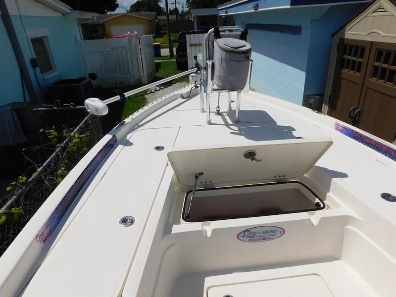 Slide: The Image of 2016 Skeeter 240SX boat deck with open storage compartment and seating. - 22