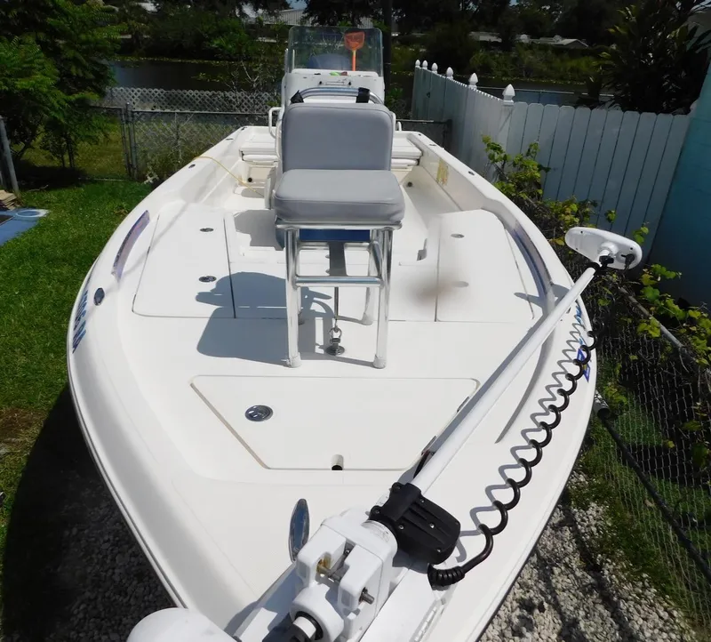 Slide: The Image of 2016 Skeeter 240SX boat with seating and trolling motor, parked outdoors. - 4
