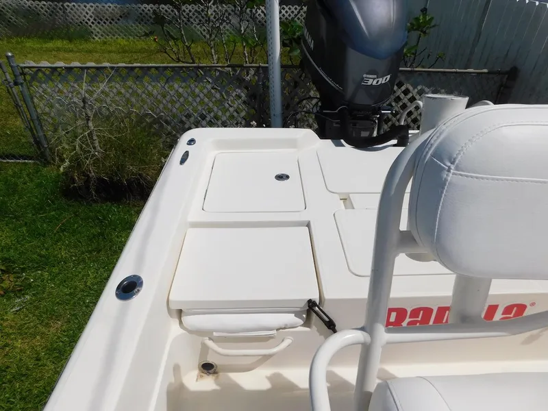 Slide: The Image of 2016 Skeeter 240SX boat with Yamaha 300 engine, white seating, and storage compartments. - 6