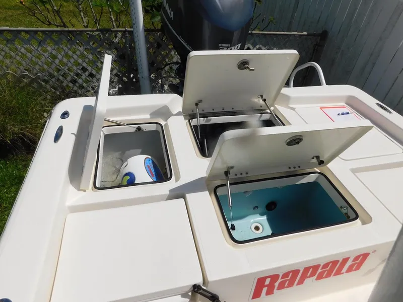 Slide: The Image of Skeeter 240SX 2016 boat with open storage compartments and Rapala branding. - 8