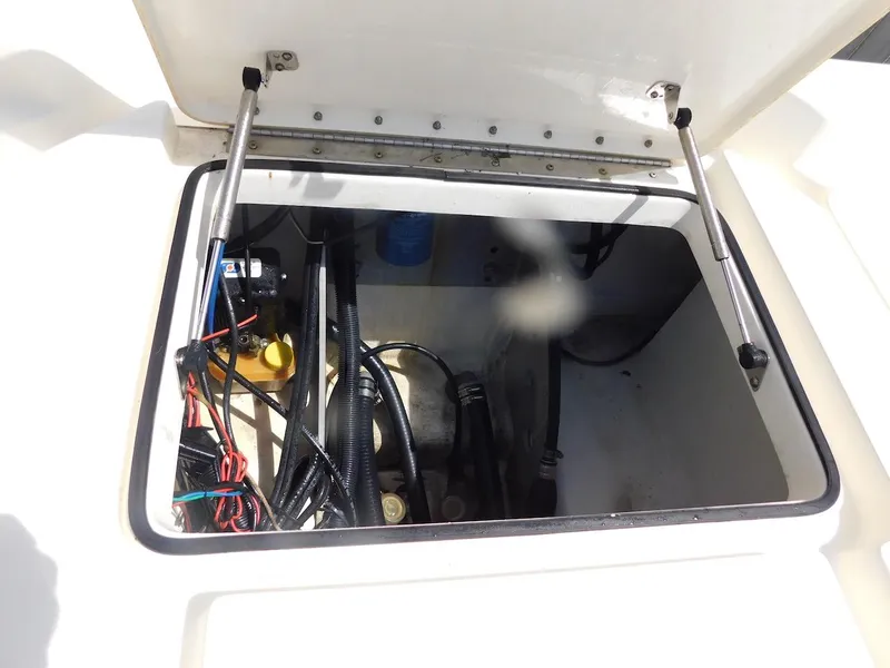 Slide: The Image of Open hatch of 2016 Skeeter 240SX boat showing internal wiring and components. - 9