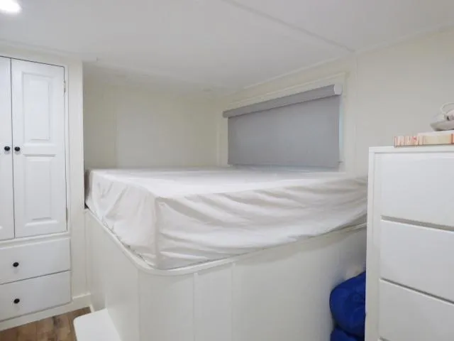 Slide: The Image of Bedroom interior of 1999 Stardust Cruisers 16x87 houseboat with bed, wardrobe, and drawers. - 6