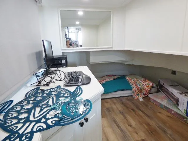 Slide: The Image of Office space in a 1999 Stardust Cruisers 16x87 houseboat with computer setup and cozy sleeping area. - 7