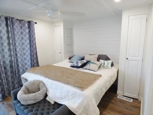 Slide: The Image of Cozy bedroom in 1999 Stardust Cruisers 16x87 houseboat with nautical decor and plush bedding. - 9