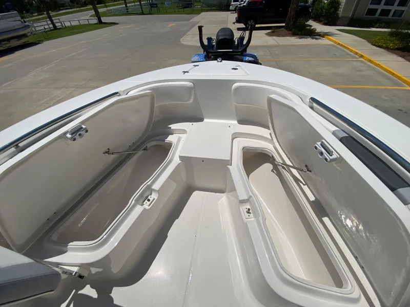 Slide: The Image of 2026 Robalo R200 Center Console boat with open storage compartments. - 18